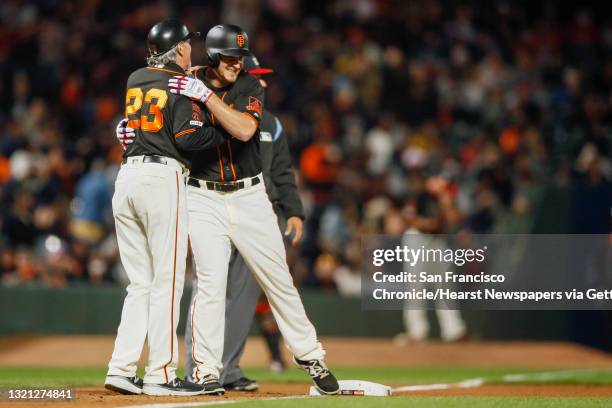 San Francisco Giants third base coach Ron Wotus with Giants outfielder Alex Dickerson after Dickerson’s triple in the 7th inning of an MLB game...