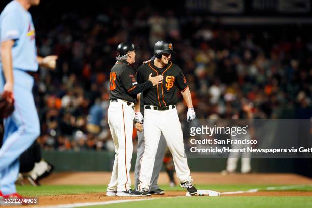 San Francisco Giants third base coach Ron Wotus with Giants outfielder Alex Dickerson after Dickerson’s triple in the 7th inning of an MLB game...