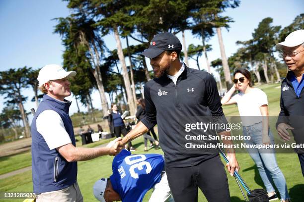 Stephen Curry , Golden State Warriors guard, talks with professional golfer Brandt Snedeker during the skills challenge at the Steph Curry Charity...