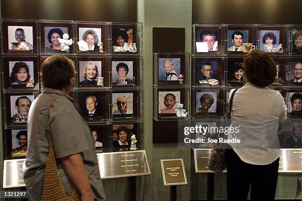 Visitors look at the faces of the victims of the 1995 Oklahoma City bombing June 11, 2001 at the Oklahoma National Memorial in Oklahoma City,...