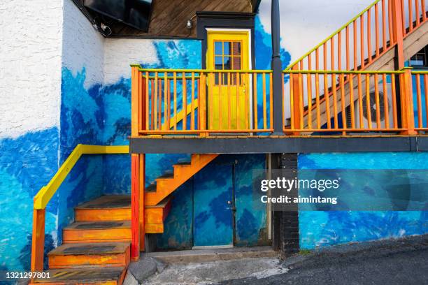 colorful painting on wall and stairs of a restaurant in downtown doylestown - doylestown stock pictures, royalty-free photos & images