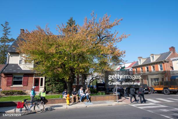 tourists eating or walking on sidewalk in downtown doylestown - doylestown stock pictures, royalty-free photos & images