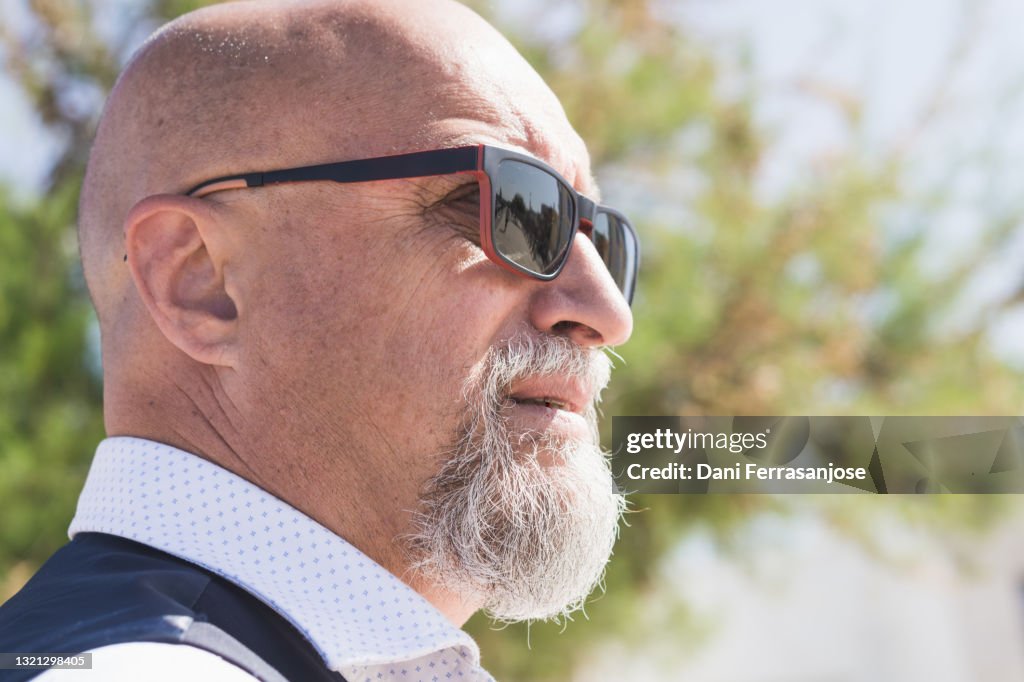 Profile Portrait Of Middleaged Bald Man With Goatee High-Res Stock
