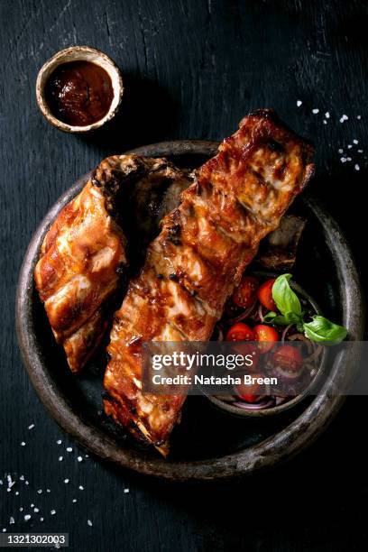 grilled pork bbq ribs served with cherry tomatoes - smoked bbq ribs stock pictures, royalty-free photos & images