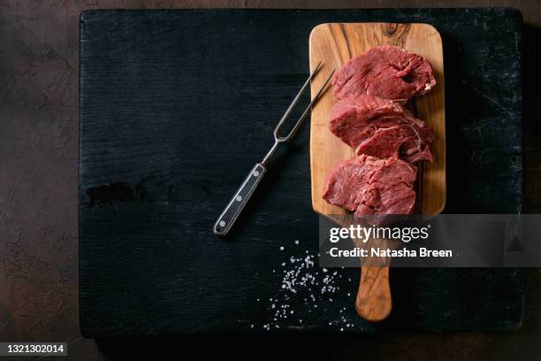 fresh whole raw beef tenderloin on wooden board - tenderloin stock pictures, royalty-free photos & images