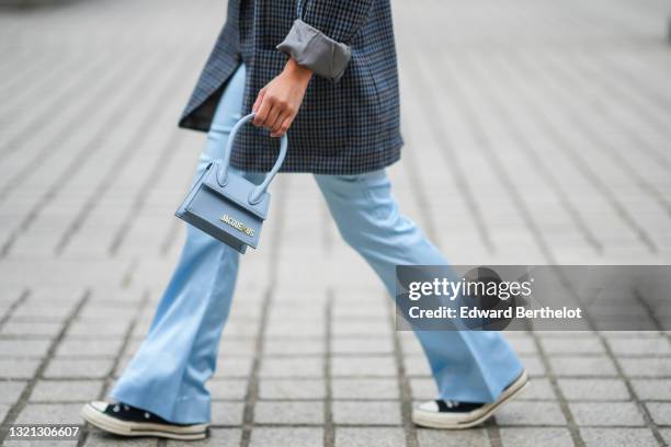 Alessandra Huynh wears a gray black and navy blue checkered oversized blazer jacket, a pale blue matte leather Chiquito Jacquemus crossbody bag, pale...