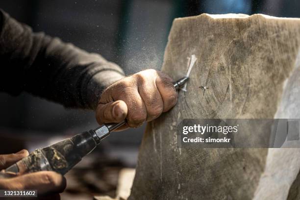 stonemason chiselling on stone - stone hand stock pictures, royalty-free photos & images