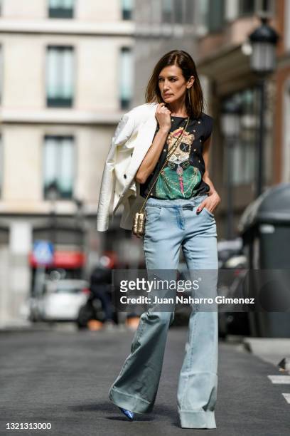 Nieves Alvarez wears The Extreme Collection T-Shirt, Rachel Zoe jeans, Elie Saab handbag, Dolce & Gabbana jacket and Etro shoes on May 24, 2021 in...