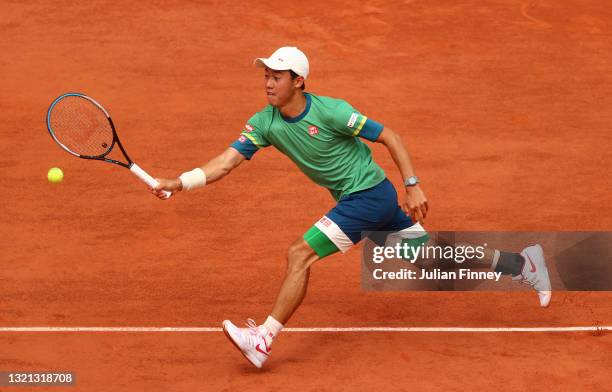 Kei Nishikori of Japan plays a forehand during his mens second round match against Karen Khachanov of Russia during day four of the 2021 French Open...