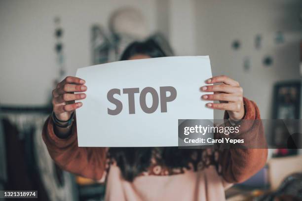 one person holding a banner with stop single word - stop sign stock pictures, royalty-free photos & images