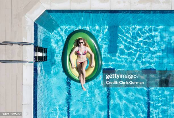 An aerial view of sunbather Eleanor Jacob posing for a portrait at Petersfield Open Air Pool on May 31,2021 in Petersfield, United Kingdom.