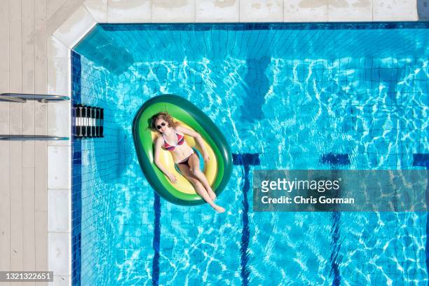An aerial view of sunbather Eleanor Jacob posing for a portrait at Petersfield Open Air Pool on May 31,2021 in Petersfield, United Kingdom.
