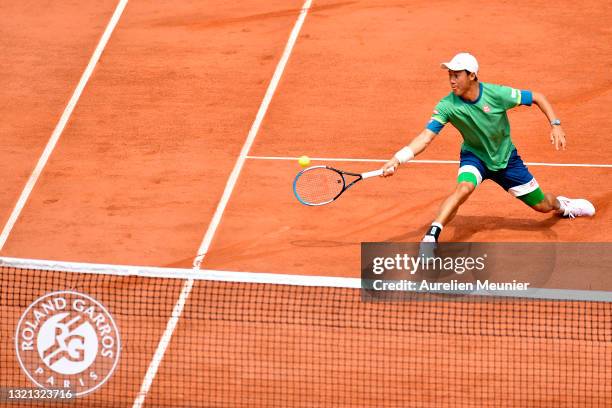 Kei Nishikori of Japan plays a forehand during his mens second round match against Karen Khachanov of Russia during day four of the 2021 French Open...