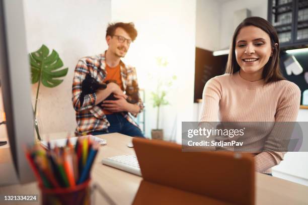 smiling woman using a digital tablet for cryptocurrency trading while working at home - couple investing stock pictures, royalty-free photos & images