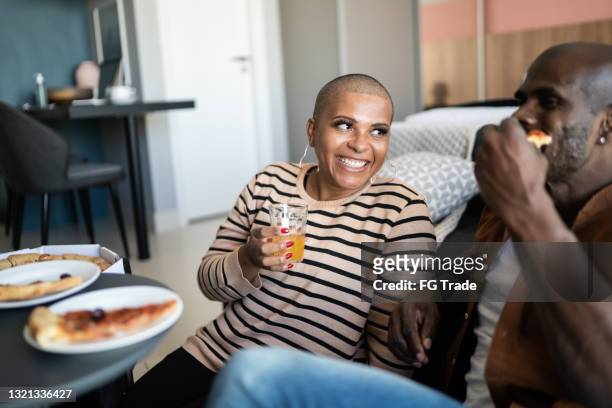 mature couple eating pizza at home - mood stream stock pictures, royalty-free photos & images