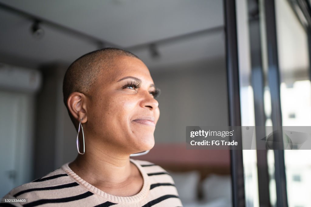 Mature woman contemplating at home