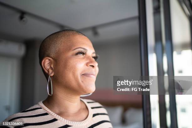 mature woman contemplating at home - hair loss stock pictures, royalty-free photos & images
