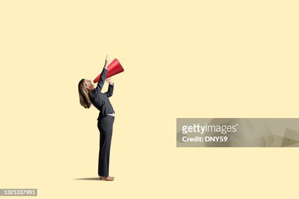 woman shouting through megaphone - megaphone stock pictures, royalty-free photos & images