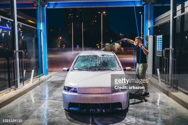 self service car wash - close up of a cleansing spray nozzle stock pictures, royalty-free photos & images
