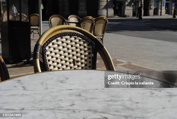 closeup of empty terrace in the city - cafe table chair outside ストックフォトと画像