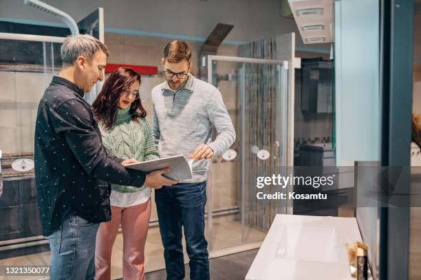 experienced salesman, using store catalog to present to his clients best products they have at their store - catalog stock pictures, royalty-free photos & images