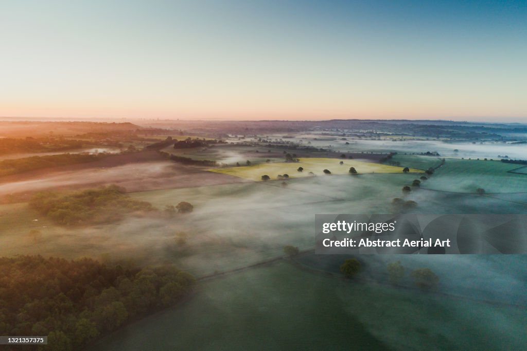 Aerial shot showing a low level mist at sunrise over the English countryside, England, United Kingdom