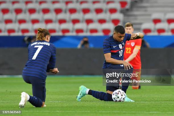 Kylian Mbappe of France takes the knee ahead of the international friendly match between France and Wales at Allianz Riviera on June 02, 2021 in...