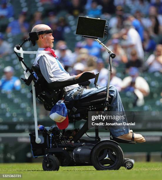 Sufferer Steve Gleason watches as his son Rivers throws a ceremonial first pitch on the first Lou Gehrig Day beofre a game between the Chicago Cubs...