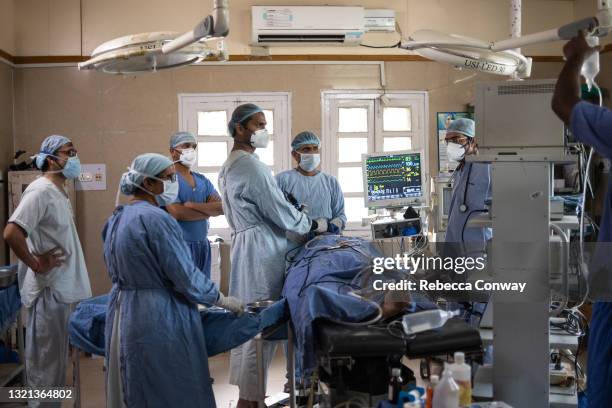 An Indian surgical team perform an endoscopic surgery to remove a fungal infection from a patient suffering from mucormycosis at the Maharao...