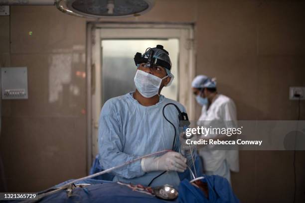 An Indian surgeon performs an endoscopic surgery to remove a fungal infection from a patient suffering from mucormycosis at the Maharao Bhimsingh...