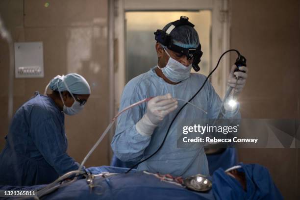 An Indian surgeon performs an endoscopic surgery to remove a fungal infection from a patient suffering from mucormycosis at the Maharao Bhimsingh...