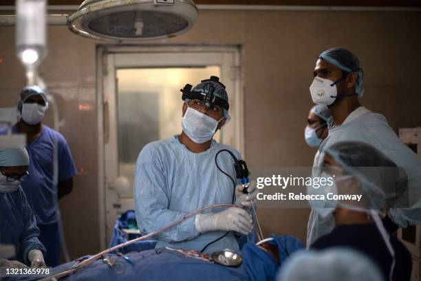 An Indian surgeon performs an endoscopic surgery to remove a fungal infection from a patient suffering from mucormycosis at the Maharao Bhimsingh...