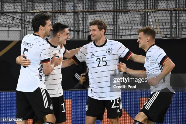 Florian Neuhaus of Germany celebrates with Mats Hummels and Thomas Muller after scoring their side's first goal during the international friendly...