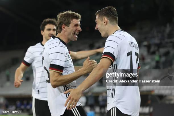 Florian Neuhaus of Germany celebrates with Thomas Muller after scoring their side's first goal during the international friendly match between...