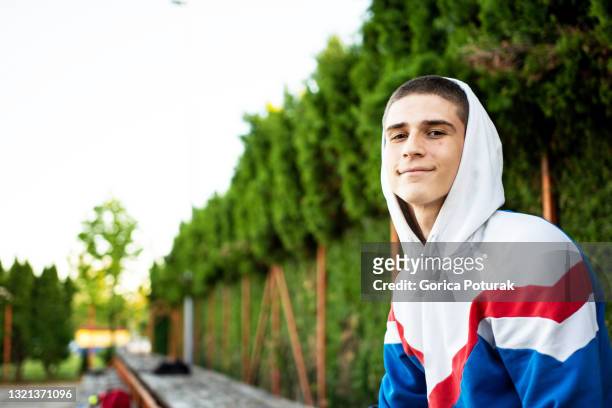 young baseball player sitting on the bench - reserve athlete stock pictures, royalty-free photos & images