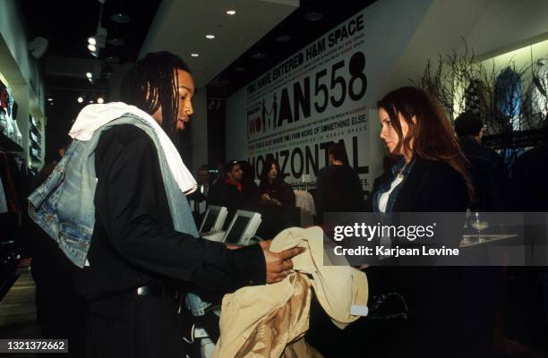 Swedish retailer H&M opens its third store in Manhattan on Lower Broadway. A cashier checks out a customer at an opening night event on March 22 in...