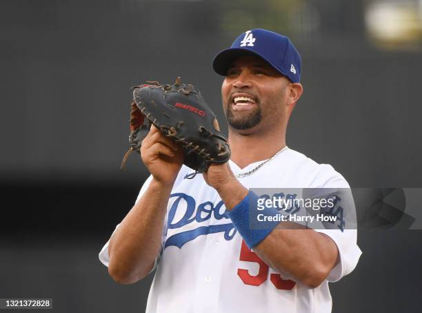 Albert Pujols of the Los Angeles Dodgers laughs as he warms up before the game against the St. Louis Cardinals at Dodger Stadium on June 01, 2021 in...