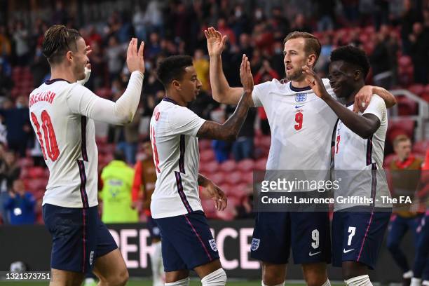 Bukayo Saka of England celebrates with Jack Grealish, Jesse Lingard and Harry Kane after scoring their side's first goal during the international...