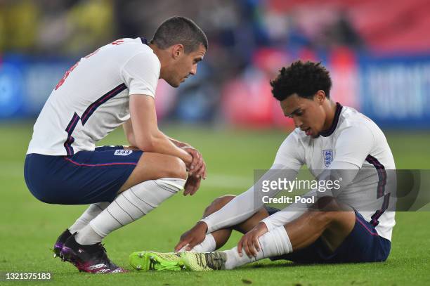 Conor Coady of England interacts with team mate Trent Alexander-Arnold after picking up an injury during the international friendly match between...