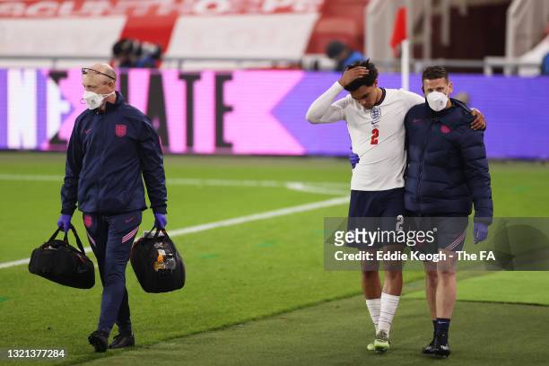 Trent Alexander-Arnold of England receives medical attention from England Physio Simon Spencer during the international friendly match between...