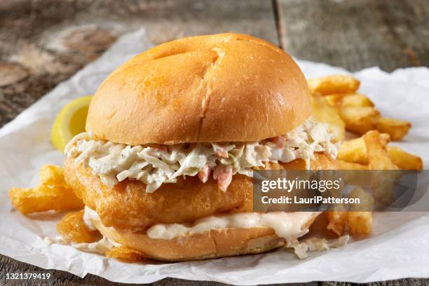 beer battered fish burger with fries - seafood platters stock pictures, royalty-free photos & images