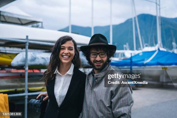 young couple walk along lakefront harbour - straight black hair stock pictures, royalty-free photos & images