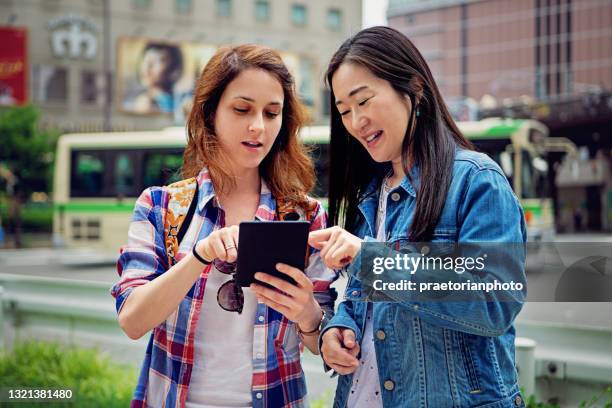 tourist asking mature woman for direction in japan - tourist asking stock pictures, royalty-free photos & images