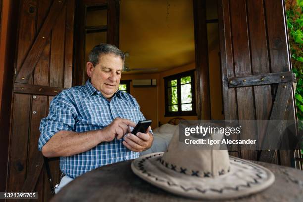 farmer sending text messages - rural internet stock pictures, royalty-free photos & images