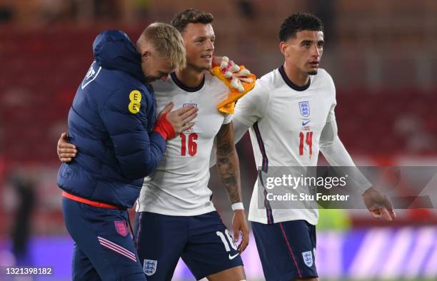 England goalkeeper Aaron Ramsdale embraces Ben White as Ben Godfrey looks on after the international friendly match between England and Austria at...