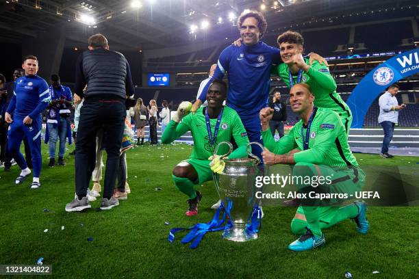 Edouard Mendy, Goalkeeper Coach Henrique Hilario, Kepa Arrizabalaga and Willy Caballero of Chelsea celebrate with the UEFA Champions League trophy...