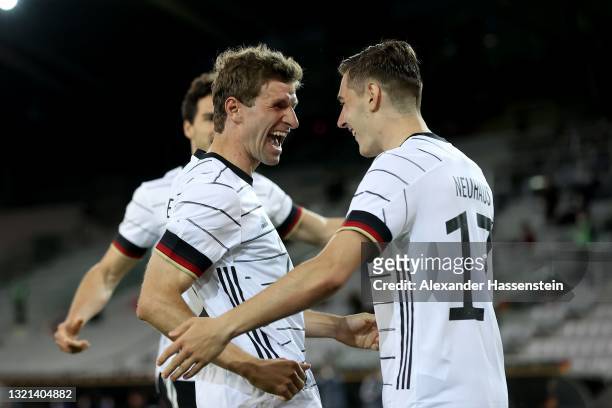 Florian Neuhaus of Germany celebrates with Thomas Muller after scoring their side's first goal during the international friendly match between...