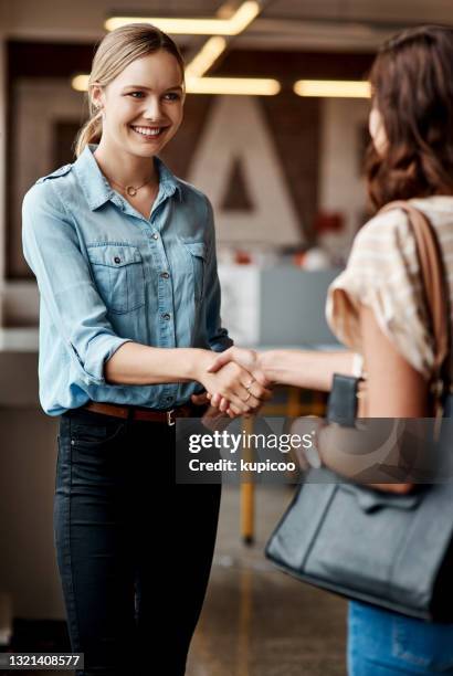 shot of a young businesswoman shaking hands with a colleague during a meeting in a modern office - casual job interview stock pictures, royalty-free photos & images