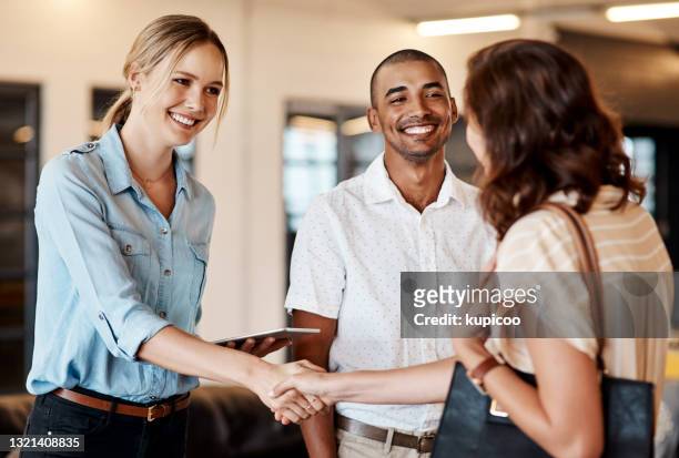 shot of a young businesswoman shaking hands with a colleague during a meeting in a modern office - interview event stock pictures, royalty-free photos & images