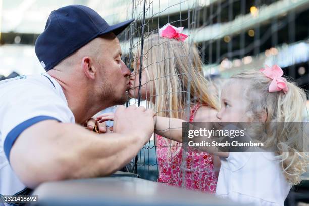 Kyle Seager of the Seattle Mariners kisses his daughter Audrey before the game against the Oakland Athletics during Lou Gehrig Day at T-Mobile Park...